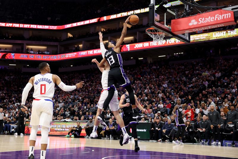 SACRAMENTO, CALIFORNIA - APRIL 02: Keegan Murray #13 of the Sacramento Kings dunks the ball on Ivica Zubac #40 of the LA Clippers in the second half at Golden 1 Center on April 02, 2024 in Sacramento, California. NOTE TO USER: User expressly acknowledges and agrees that, by downloading and or using this photograph, User is consenting to the terms and conditions of the Getty Images License Agreement.  (Photo by Ezra Shaw/Getty Images)