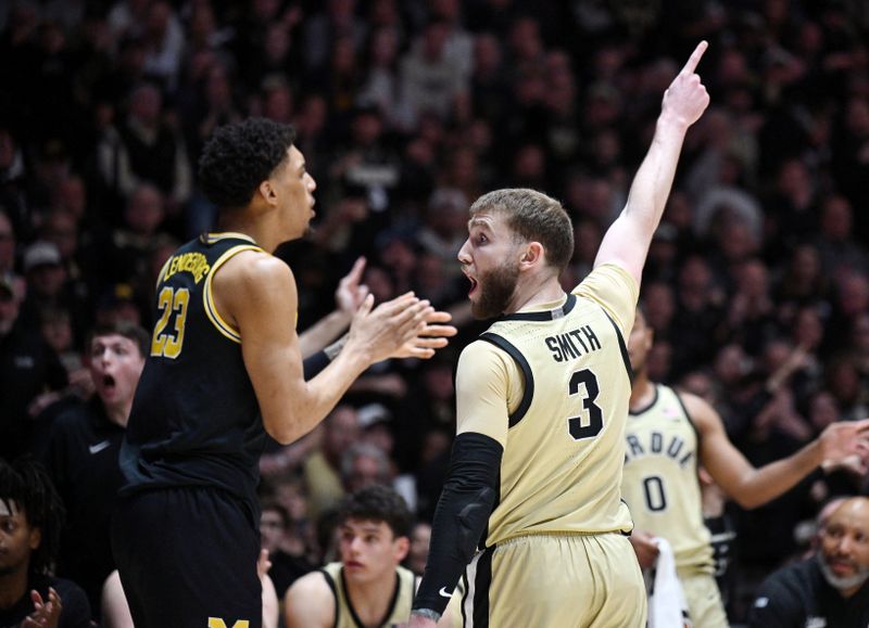 Feb 17, 2026; West Lafayette, Indiana, USA; Purdue Boilermakers guard Braden Smith (3) and Michigan Wolverines forward Yaxel Lendeborg (23) react very differently to a call during the first half at Mackey Arena. Mandatory Credit: Marc Lebryk-Imagn Images