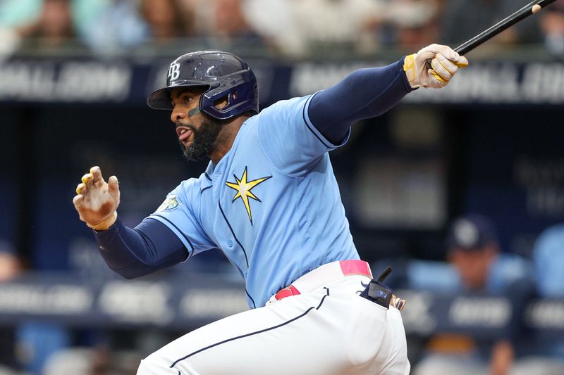 Jul 9, 2023; St. Petersburg, Florida, USA;  Tampa Bay Rays designated hitter Yandy Diaz (2) singles against the Atlanta Braves in the first inning at Tropicana Field. Mandatory Credit: Nathan Ray Seebeck-USA TODAY Sports