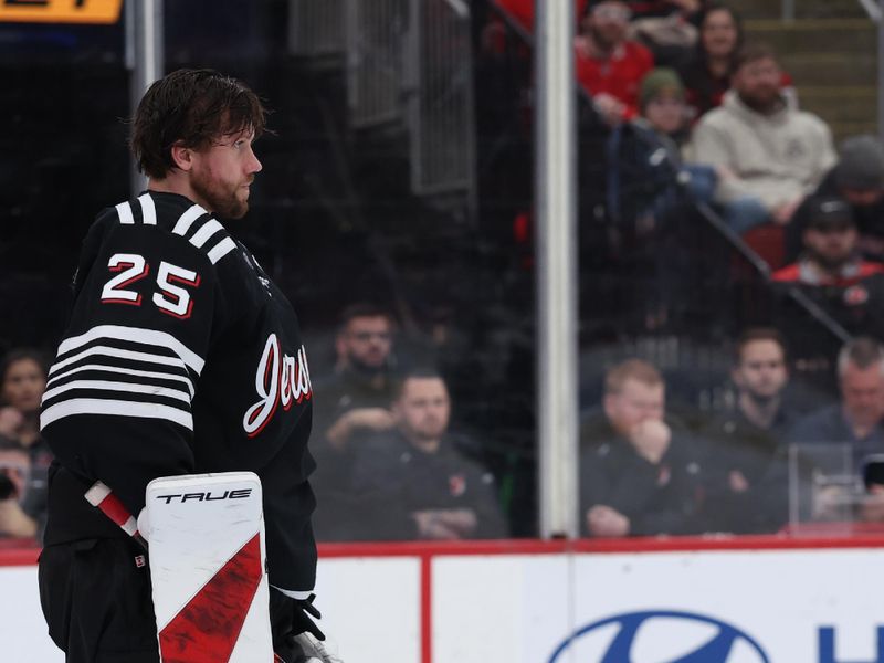 Jan 17, 2026; Newark, New Jersey, USA; New Jersey Devils goaltender Jacob Markstrom (25) gathers his helmet after play stopped against the Carolina Hurricanes during the third period at Prudential Center. Mandatory Credit: Thomas Salus-Imagn Images