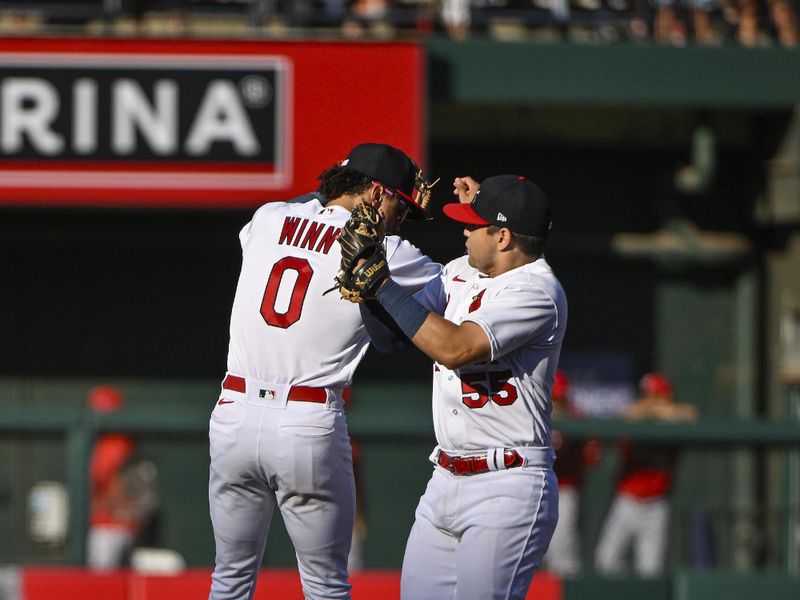 Oct 1, 2023; St. Louis, Missouri, USA;  St. Louis Cardinals shortstop Masyn Winn (0) and second baseman Irving Lopez (55) celebrate after the Cardinals defeated the Cincinnati Reds at Busch Stadium. Mandatory Credit: Jeff Curry-USA TODAY Sports