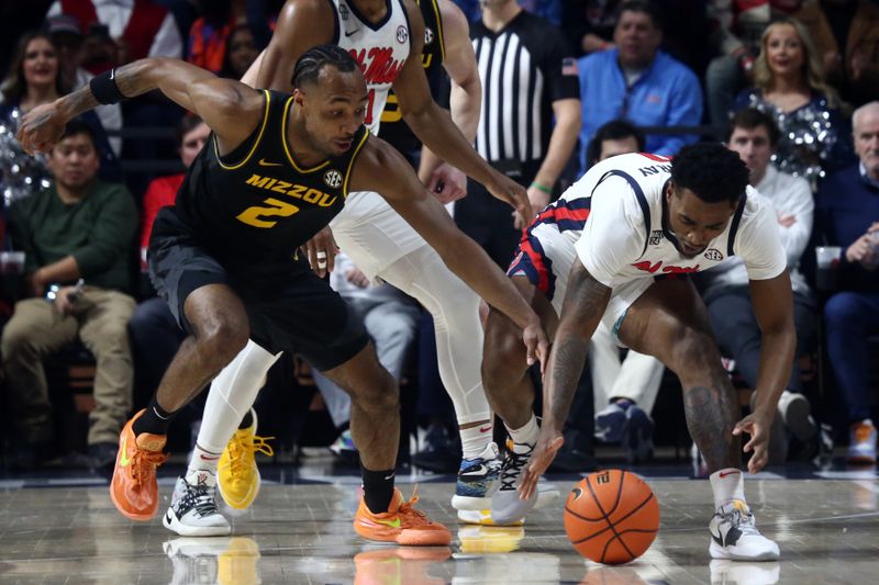 Feb 17, 2024; Oxford, Mississippi, USA; Missouri Tigers guard Tamar Bates (2) and Mississippi Rebels guard Brandon Murray (0) battle for a loose ball during the first half at The Sandy and John Black Pavilion at Ole Miss. Mandatory Credit: Petre Thomas-USA TODAY Sports