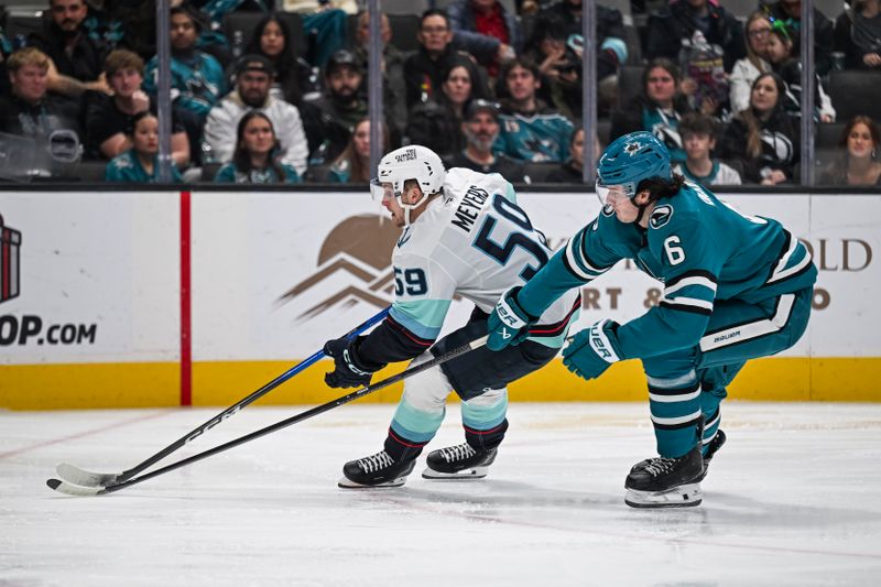 Dec 20, 2025; San Jose, California, USA; Seattle Kraken center Ben Meyers (59) and San Jose Sharks defenseman Sam Dickinson (6) go for the puck during the first period at SAP Center at San Jose. Mandatory Credit: Justine Willard-Imagn Images
