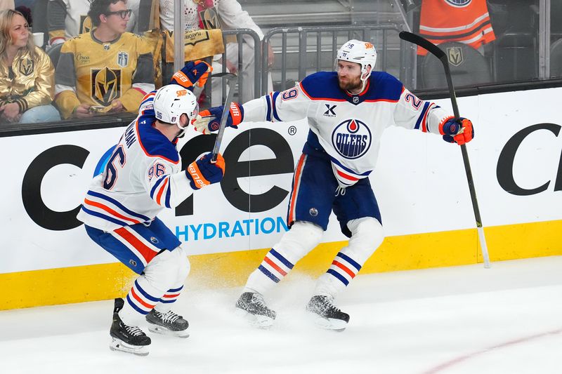 May 8, 2025; Las Vegas, Nevada, USA; Edmonton Oilers center Leon Draisaitl (29) celebrates with defenseman Jake Walman (96) after scoring a game-winning goal against the Vegas Golden Knights during an overtime period of game two of the second round of the 2025 Stanley Cup Playoffs at T-Mobile Arena. Mandatory Credit: Stephen R. Sylvanie-Imagn Images
