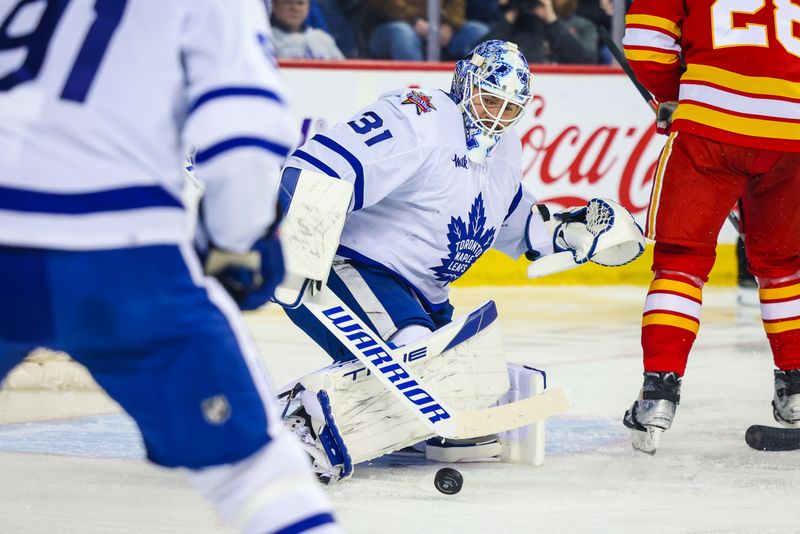 Jan 18, 2024; Calgary, Alberta, CAN; Toronto Maple Leafs goaltender Martin Jones (31) makes a save against the Calgary Flames during the second period at Scotiabank Saddledome. Mandatory Credit: Sergei Belski-USA TODAY Sports