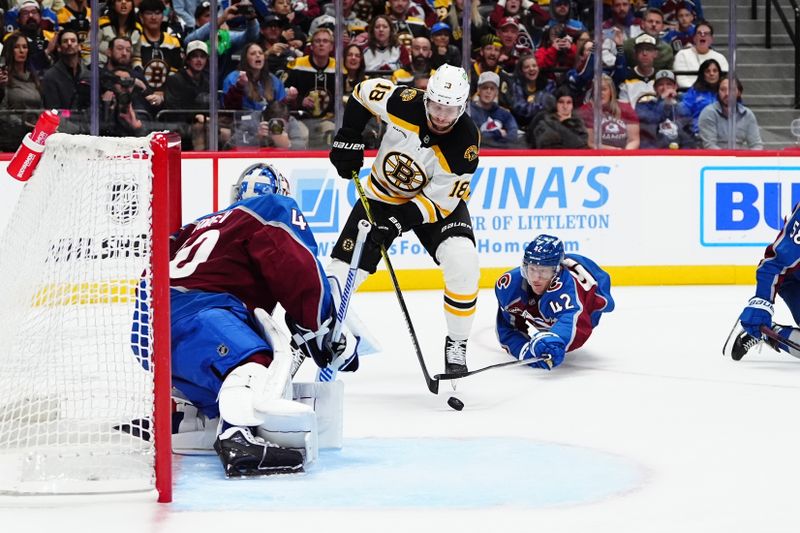 Oct 16, 2024; Denver, Colorado, USA; Boston Bruins center Pavel Zacha (18) shoots the puck at Colorado Avalanche goaltender Alexandar Georgiev (40) as defenseman Josh Manson (42) reaches in the third period at Ball Arena. Mandatory Credit: Ron Chenoy-Imagn Images