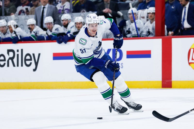 Jan 14, 2025; Winnipeg, Manitoba, CAN;  Vancouver Canucks defenseman Tyler Myers (57) skates into the Winnipeg Jets zone  during the first period at Canada Life Centre. Mandatory Credit: Terrence Lee-Imagn Images