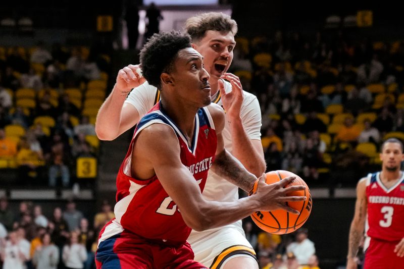 Jan 31, 2023; Laramie, Wyoming, USA; Fresno State Bulldogs guard Leo Colimerio (23) drives against Wyoming Cowboys guard Hunter Maldonado (24) during the first half at Arena-Auditorium. Mandatory Credit: Troy Babbitt-USA TODAY Sports