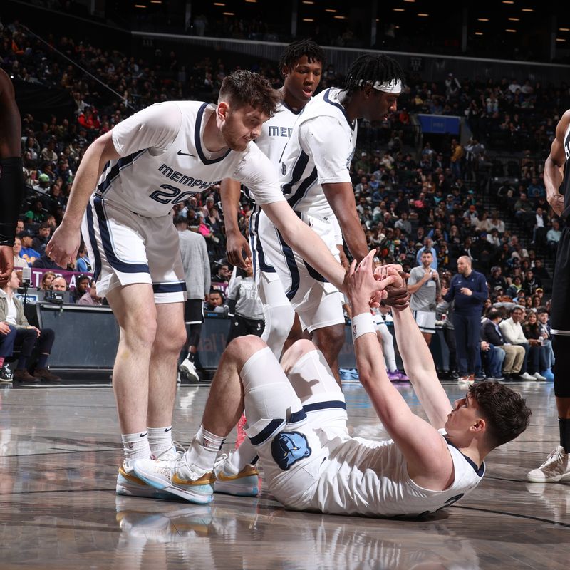 BROOKLYN, NY - MARCH 4: Matt Hurt #20 and Vince Williams Jr. #5 help up Jake LaRavia #3 of the Memphis Grizzlies during the game against the Brooklyn Nets on March 4, 2024 at Barclays Center in Brooklyn, New York. NOTE TO USER: User expressly acknowledges and agrees that, by downloading and or using this Photograph, user is consenting to the terms and conditions of the Getty Images License Agreement. Mandatory Copyright Notice: Copyright 2024 NBAE (Photo by Nathaniel S. Butler/NBAE via Getty Images)