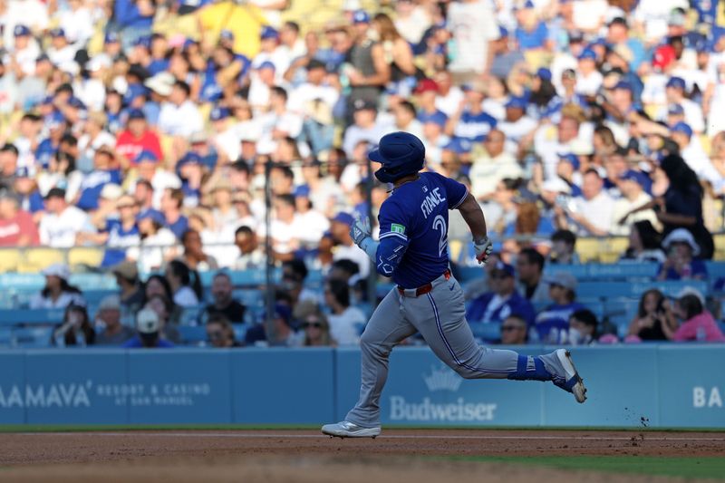 Aug 9, 2025; Los Angeles, California, USA; Toronto Blue Jays first base Ty France (2) runs toward second base after hitting a double against the Los Angeles Dodgers during the second inning at Dodger Stadium. Mandatory Credit: Kiyoshi Mio-Imagn Images