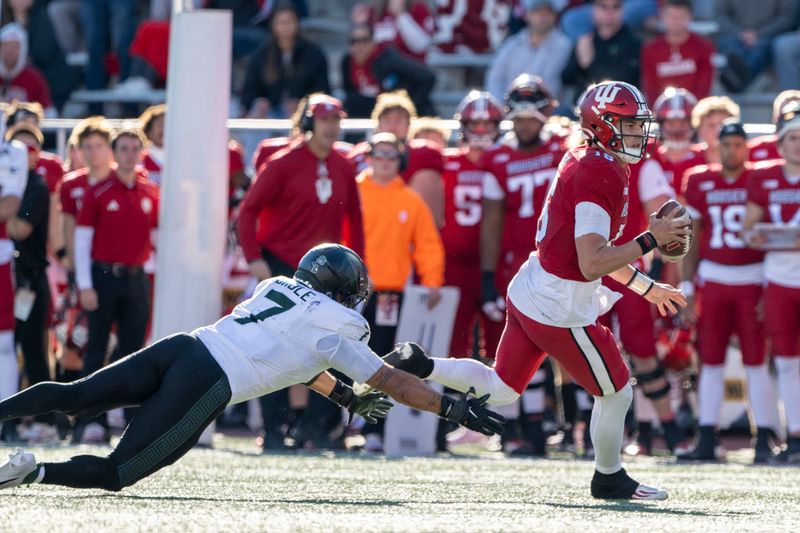 Nov 18, 2023; Bloomington, Indiana, USA; Indiana Hoosiers quarterback Brendan Sorsby (15) outruns Michigan State Spartans linebacker Aaron Brule (7) during the second half at Memorial Stadium. Mandatory Credit: Marc Lebryk-USA TODAY Sports