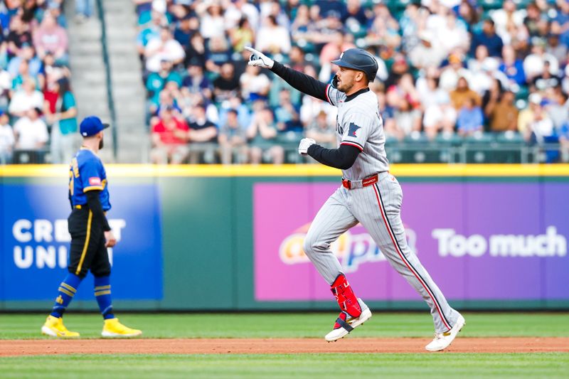May 30, 2025; Seattle, Washington, USA; Minnesota Twins designated hitter Trevor Larnach (9) celebrates while running the bases following a solo-home run against the Seattle Mariners during the fourth inning at T-Mobile Park. Mandatory Credit: Joe Nicholson-Imagn Images