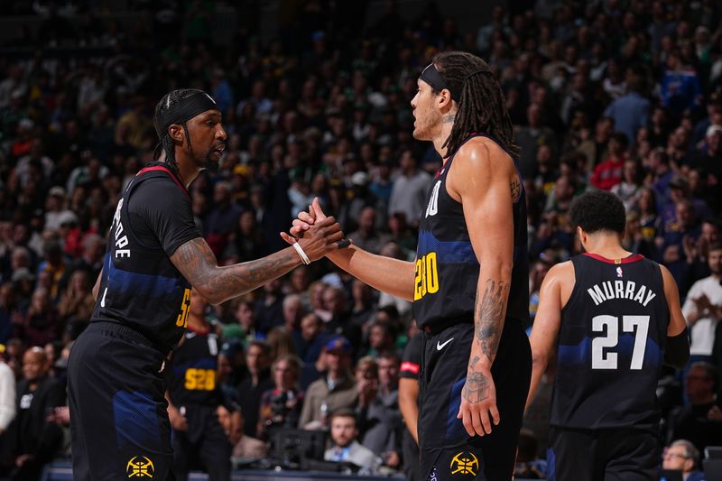 DENVER, CO - MARCH 7: Kentavious Caldwell-Pope #5 high fives Aaron Gordon #50 of the Denver Nuggets during the game against the Boston Celtics on March 7, 2024 at the Ball Arena in Denver, Colorado. NOTE TO USER: User expressly acknowledges and agrees that, by downloading and/or using this Photograph, user is consenting to the terms and conditions of the Getty Images License Agreement. Mandatory Copyright Notice: Copyright 2024 NBAE (Photo by Bart Young/NBAE via Getty Images)