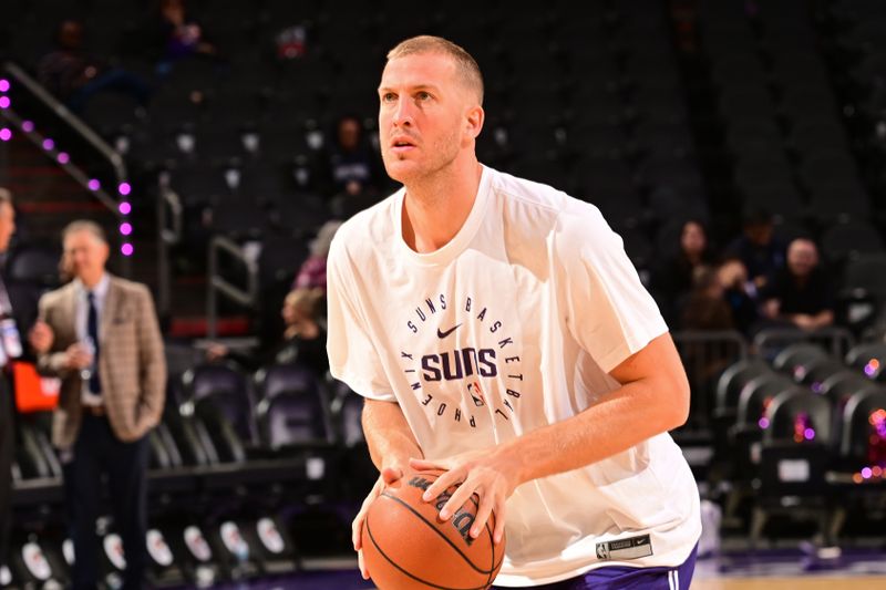 PHOENIX, AZ - NOVEMBER 18: Mason Plumlee #22 of the Phoenix Suns warms up before the game against the Orlando Magic on November 18, 2024 at Footprint Center in Phoenix, Arizona. NOTE TO USER: User expressly acknowledges and agrees that, by downloading and or using this photograph, user is consenting to the terms and conditions of the Getty Images License Agreement. Mandatory Copyright Notice: Copyright 2024 NBAE (Photo by Kate Frese/NBAE via Getty Images)