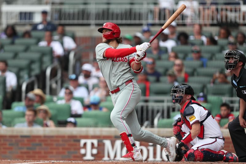 Jun 29, 2025; Cumberland, Georgia, Philadelphia Phillies third baseman Alec Bohm (28) hits a double during a game against the Atlanta Braves during the eighth inning at Truist Park. Mandatory Credit: Mady Mertens-Imagn Images