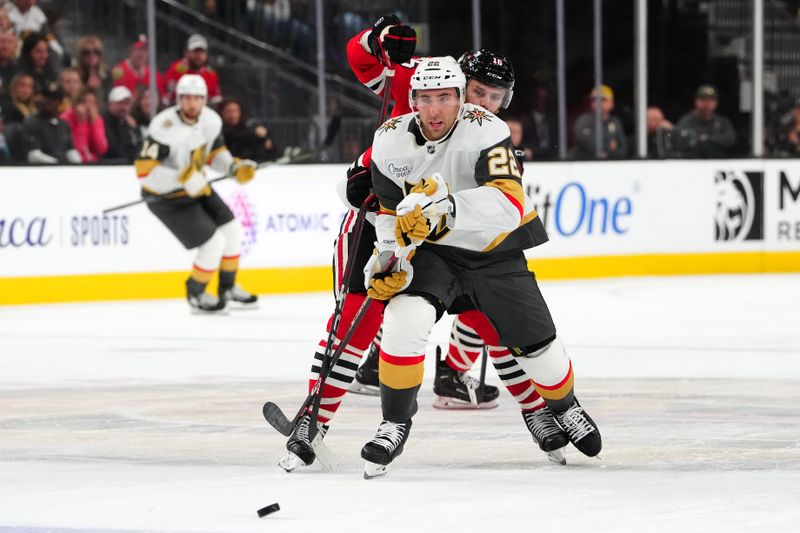 Oct 27, 2023; Las Vegas, Nevada, USA; Chicago Blackhawks center Jason Dickinson (16) ties up the stick of Vegas Golden Knights right wing Michael Amadio (22) during the third period at T-Mobile Arena. Mandatory Credit: Stephen R. Sylvanie-USA TODAY Sports