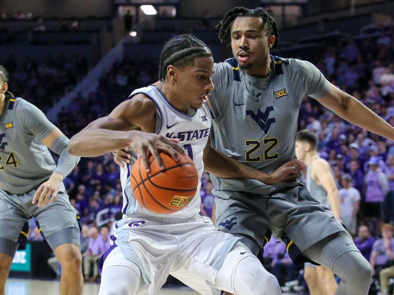 Feb 26, 2024; Manhattan, Kansas, USA; Kansas State Wildcats forward David N'Guessan (1) is guarded by West Virginia Mountaineers forward Josiah Harris (22) during the first half at Bramlage Coliseum. Mandatory Credit: Scott Sewell-USA TODAY Sports