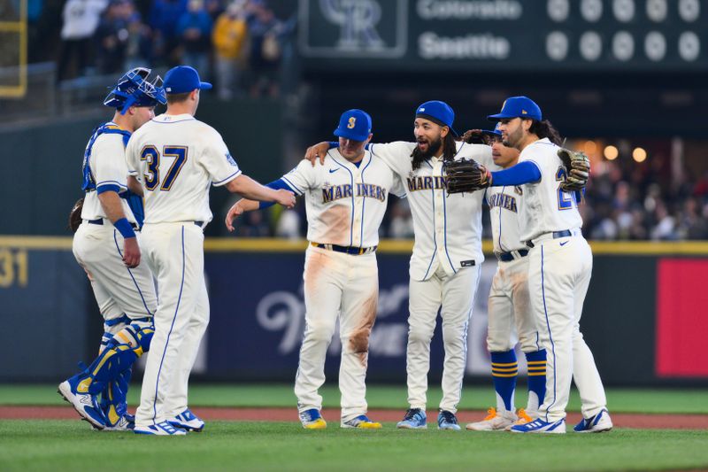 Apr 16, 2023; Seattle, Washington, USA; The Seattle Mariners infielders celebrate defeating the Colorado Rockies at T-Mobile Park. Mandatory Credit: Steven Bisig-USA TODAY Sports