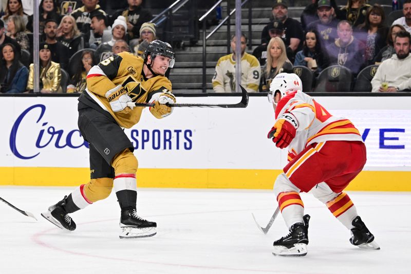 Oct 28, 2024; Las Vegas, Nevada, USA; Vegas Golden Knights left wing Pavel Dorofeyev (16) shoots the puck past Calgary Flames defenseman Joel Hanley (44) in the second period at T-Mobile Arena. Mandatory Credit: Candice Ward-Imagn Images