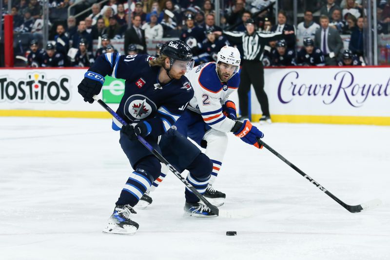 Nov 30, 2023; Winnipeg, Manitoba, CAN; Winnipeg Jets forward Kyle Connor (81) tries to skate in on Edmonton Oilers defenseman Evan Bouchard (2) during the second period at Canada Life Centre. Mandatory Credit: Terrence Lee-USA TODAY Sports