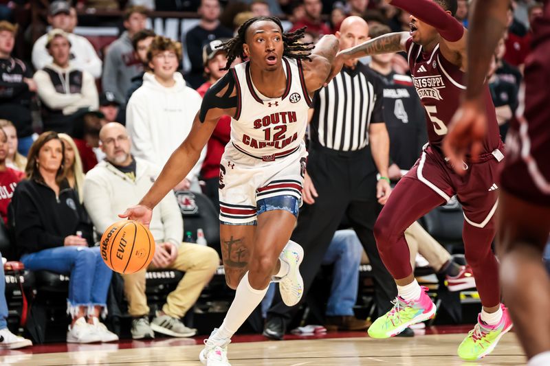 Jan 6, 2024; Columbia, South Carolina, USA; South Carolina Gamecocks guard Zachary Davis (12) drives around Mississippi State Bulldogs guard Shawn Jones Jr. (5) in the first half at Colonial Life Arena. Mandatory Credit: Jeff Blake-USA TODAY Sports