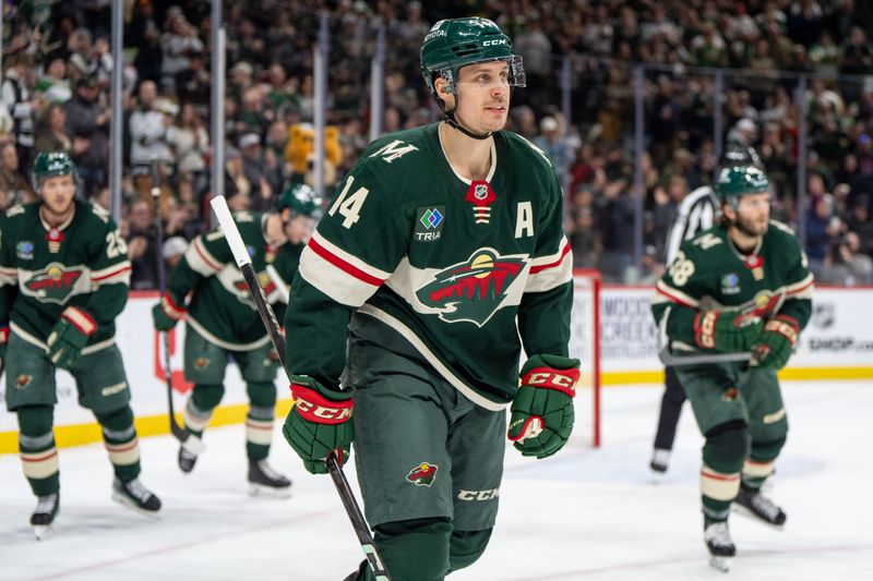 Jan 7, 2025; Saint Paul, Minnesota, USA; Minnesota Wild center Joel Eriksson Ek (14) skates to the bench with teammates after scoring against the St. Louis Blues in the second period at Xcel Energy Center. Mandatory Credit: Matt Blewett-Imagn Images