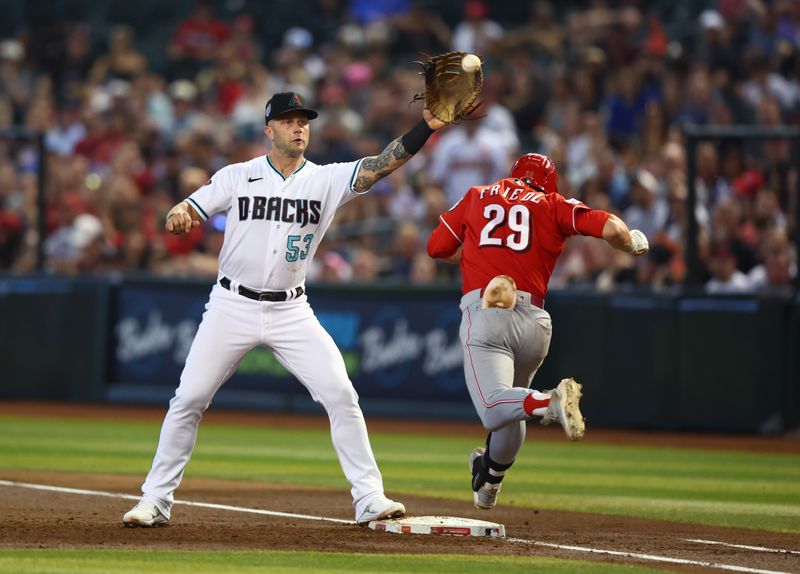 Aug 27, 2023; Phoenix, Arizona, USA; Arizona Diamondbacks first baseman Christian Walker (53) fields a ball for an out against Cincinnati Reds base runner TJ Friedl in the third inning at Chase Field. Mandatory Credit: Mark J. Rebilas-USA TODAY Sports