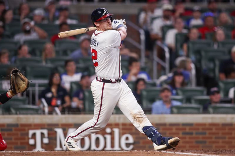 May 8, 2025; Atlanta, Georgia, USA; Atlanta Braves catcher Sean Murphy (12) hits a single against the Cincinnati Reds in the ninth inning at Truist Park. Mandatory Credit: Brett Davis-Imagn Images
