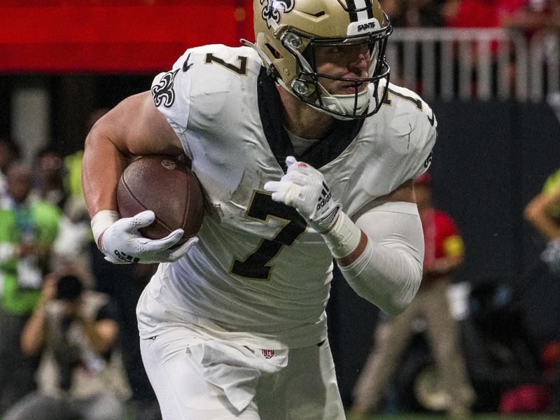 New Orleans Saints tight end Taysom Hill (7) runs towards the end zone for a touchdown during the first half of an NFL football game against the Atlanta Falcons, Sunday, Sep. 11, 2022, in Atlanta. (AP Photo/Danny Karnik)