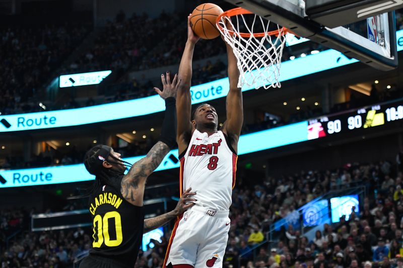 SALT LAKE CITY, UTAH - DECEMBER 30: Jamal Cain #8 of the Miami Heat dunks over Jordan Clarkson #00 of the Utah Jazz during the second half of a game at Delta Center on December 30, 2023 in Salt Lake City, Utah. NOTE TO USER: User expressly acknowledges and agrees that, by downloading and or using this photograph, User is consenting to the terms and conditions of the Getty Images License Agreement. (Photo by Alex Goodlett/Getty Images)