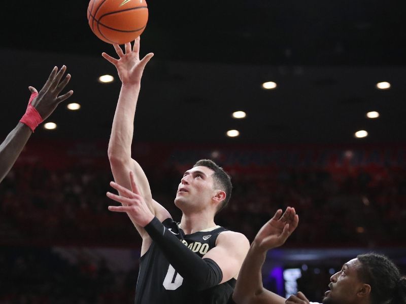 Feb 18, 2023; Tucson, Arizona, USA; Colorado Buffaloes guard Luke O'Brien (0) makes a basket against Arizona Wildcats guard Cedric Henderson Jr. (45)  during the first half at McKale Center. Mandatory Credit: Zachary BonDurant-USA TODAY Sports