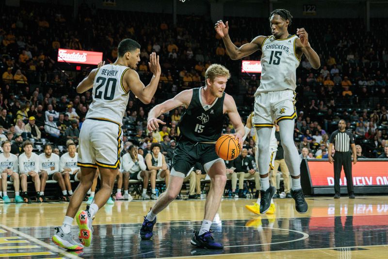 Mar 2, 2024; Wichita, Kansas, USA; Rice Owls forward Max Fiedler (15) looks for an opening between Wichita State Shockers guard Harlond Beverly (20) and Wichita State Shockers center Quincy Ballard (15) during the second half at Charles Koch Arena. Mandatory Credit: William Purnell-USA TODAY Sports