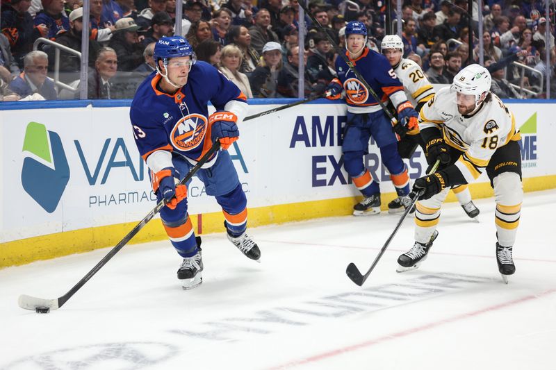 Nov 26, 2025; Elmont, New York, USA; New York Islanders center Mathew Barzal (13) attempts to skate past Boston Bruins center Pavel Zacha (18) in the second period at UBS Arena. Mandatory Credit: Wendell Cruz-Imagn Images