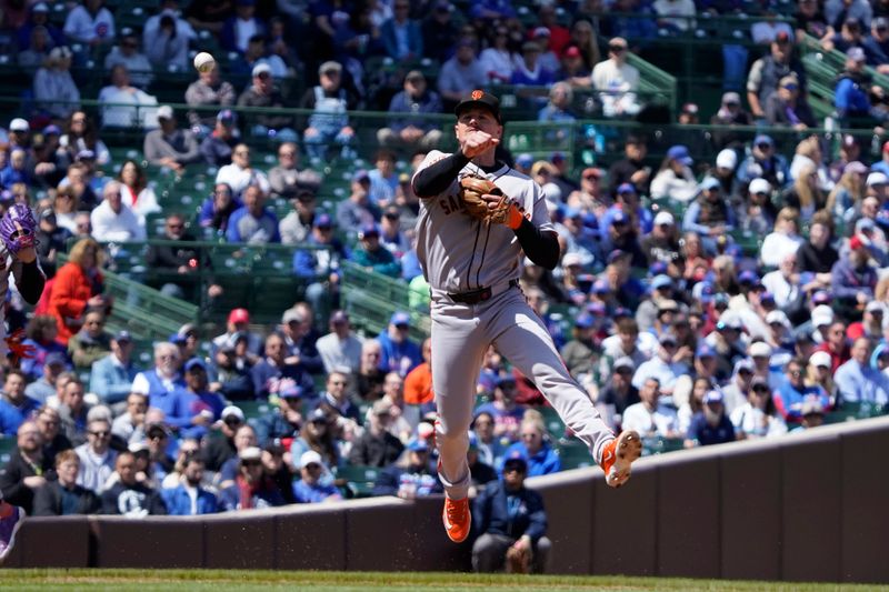 May 7, 2025; Chicago, Illinois, USA; San Francisco Giants third base Matt Chapman (26) throws out Chicago Cubs this base Jon Berti (5) during the third inning at Wrigley Field. Mandatory Credit: David Banks-Imagn Images