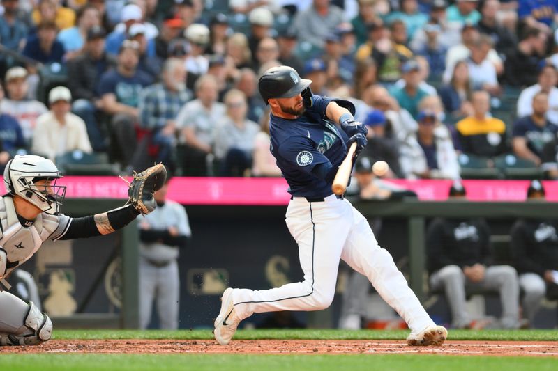 Jun 10, 2024; Seattle, Washington, USA; Seattle Mariners designated hitter Mitch Haniger (17) hits a double against the Chicago White Sox during the second inning at T-Mobile Park. Mandatory Credit: Steven Bisig-USA TODAY Sports