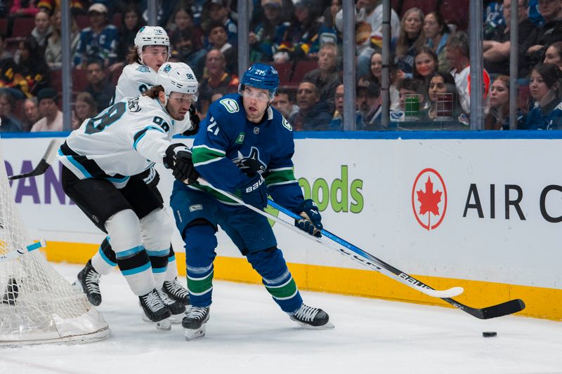 Mar 16, 2025; Vancouver, British Columbia, CAN; Utah Hockey Club defenseman Mikhail Sergachev (98) stick checks Vancouver Canucks forward Nils Hoglander (21) in the first period at Rogers Arena. Mandatory Credit: Bob Frid-Imagn Images