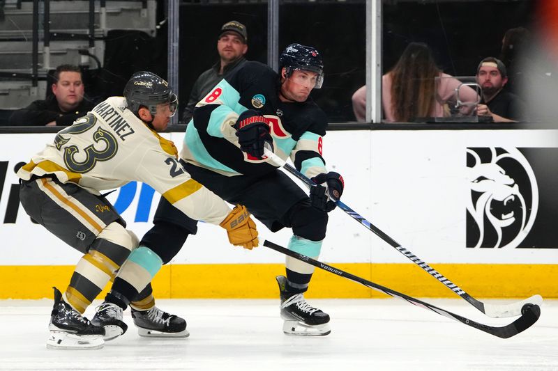 Mar 21, 2024; Las Vegas, Nevada, USA; Seattle Kraken defenseman Brian Dumoulin (8) shoots against the stick of Vegas Golden Knights defenseman Alec Martinez (23) during the third period at T-Mobile Arena. Mandatory Credit: Stephen R. Sylvanie-USA TODAY Sports