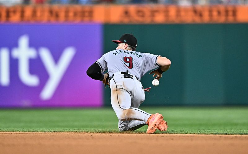 Jun 21, 2024; Philadelphia, Pennsylvania, USA; Arizona Diamondbacks infielder Blaze Alexander (9) drops the ball to allow a run against the Philadelphia Phillies in the seventh inning at Citizens Bank Park. Mandatory Credit: Kyle Ross-USA TODAY Sports