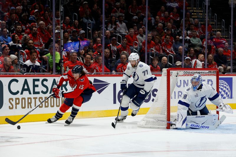 Oct 14, 2025; Washington, District of Columbia, USA; Washington Capitals left wing Sonny Milano (15) skates with the puck behind Tampa Bay Lightning goaltender Andrei Vasilevskiy (88) as Lightning defenseman Victor Hedman (77) chases in the first period at Capital One Arena. Mandatory Credit: Geoff Burke-Imagn Images