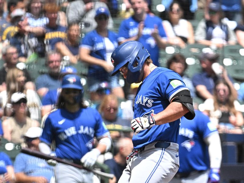 Jun 12, 2024; Milwaukee, Wisconsin, USA; Toronto Blue Jays outfielder Davis Schneider (36) touches home plate after hitting home run against the Milwaukee Brewers in the first inning at American Family Field. Mandatory Credit: Michael McLoone-USA TODAY Sports