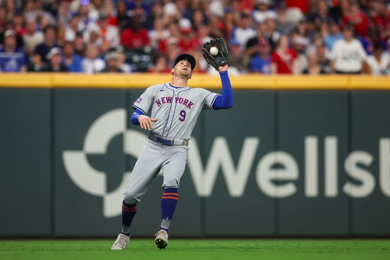 Sep 24, 2024; Atlanta, Georgia, USA; New York Mets left fielder Brandon Nimmo (9) catches a fly ball against the Atlanta Braves in the sixth inning at Truist Park. Mandatory Credit: Brett Davis-Imagn Images