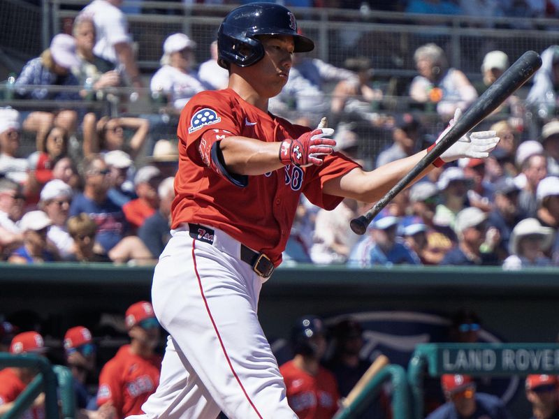 Mar 11, 2025; Fort Myers, Florida, USA; Boston Red Sox Masataka Yoshida (7) flies out to left field during their spring training game with the Phillies at JetBlue Park at Fenway South. Mandatory Credit: Chris Tilley-Imagn Images