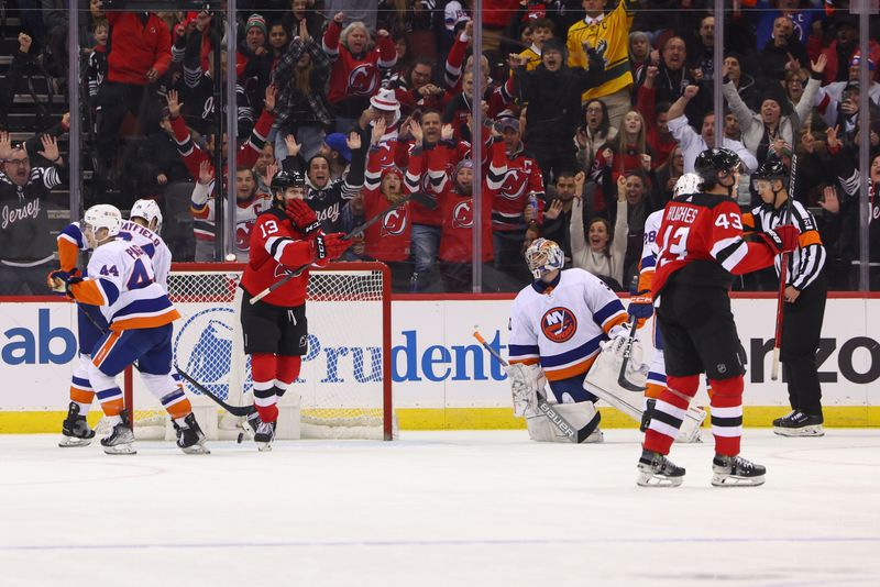 Nov 28, 2023; Newark, New Jersey, USA; New Jersey Devils center Nico Hischier (13) celebrates his goal against the New York Islanders during the third period at Prudential Center. Mandatory Credit: Ed Mulholland-USA TODAY Sports