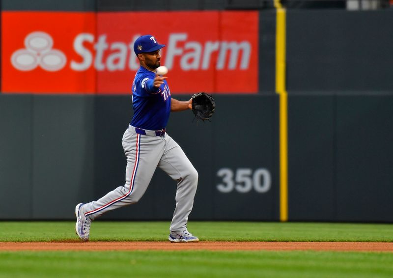 May 11, 2024; Denver, Colorado, USA; Texas Rangers second base Marcus Semien (2) makes a throw to first base for an out against the Colorado Rockies during the fourth inning at Coors Field. Mandatory Credit: John Leyba-USA TODAY Sports