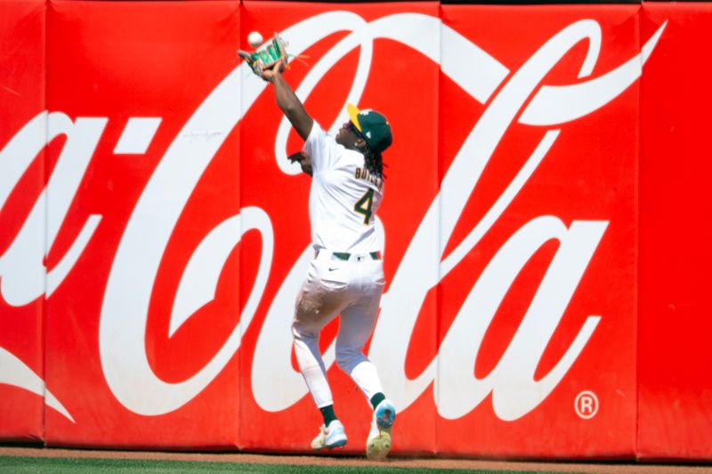 Jul 20, 2024; Oakland, California, USA; Oakland Athletics right fielder Lawrence Butler (4) makes the catch of a deep fly ball by Los Angeles Angels second baseman Luis Guillorme during the ninth inning at Oakland-Alameda County Coliseum. Mandatory Credit: D. Ross Cameron-USA TODAY Sports