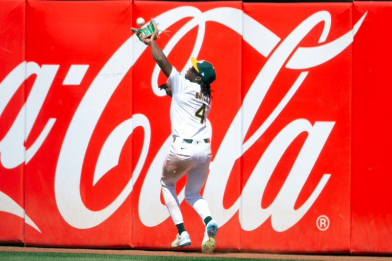 Jul 20, 2024; Oakland, California, USA; Oakland Athletics right fielder Lawrence Butler (4) makes the catch of a deep fly ball by Los Angeles Angels second baseman Luis Guillorme during the ninth inning at Oakland-Alameda County Coliseum. Mandatory Credit: D. Ross Cameron-USA TODAY Sports