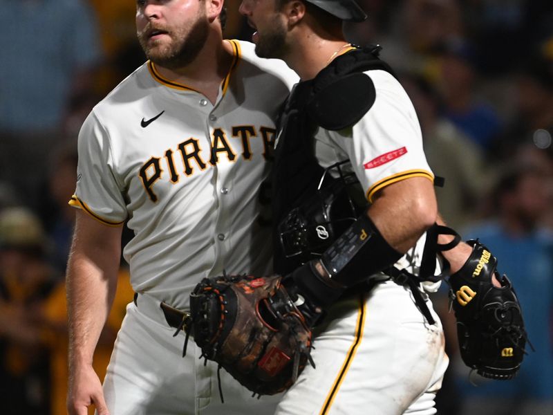 Aug 3, 2024; Pittsburgh, Pennsylvania, USA;  Pittsburgh Pirates closing pitcher David Bednar (51) celebrates with catcher Joey Bart (14) after defeating the Arizona Diamondbacks at PNC Park. Mandatory Credit: Philip G. Pavely-USA TODAY Sports