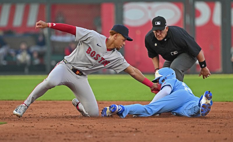 May 10, 2025; Kansas City, Missouri, USA;  Boston Red Sox second baseman Kristian Campbell tags out Kansas City Royals left fielder Mark Canha attempting to steal second base in the third inning at Kauffman Stadium. Mandatory Credit: Peter Aiken-Imagn Images