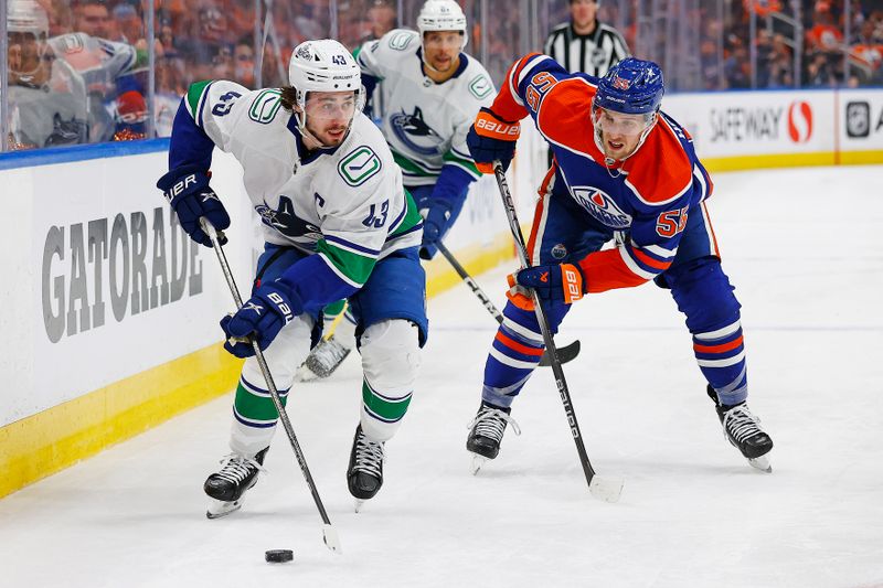 May 14, 2024; Edmonton, Alberta, CAN; Vancouver Canucks defensemen Quinn Hughes (43) looks to make a pass in front of Edmonton Oilers forward Dylan Holloway (55) during the second period in game four of the second round of the 2024 Stanley Cup Playoffs at Rogers Place. Mandatory Credit: Perry Nelson-USA TODAY Sports