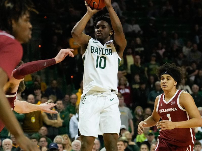 Feb 8, 2023; Waco, Texas, USA;  Baylor Bears guard Adam Flagler (10) scores a three point basket past Oklahoma Sooners forward Jalen Hill (1) during the second half at Ferrell Center. Mandatory Credit: Chris Jones-USA TODAY Sports